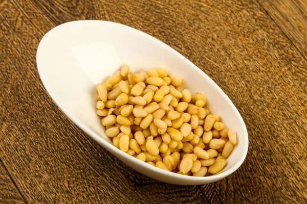 Cedar nuts in the bowl — Stock Photo, Image