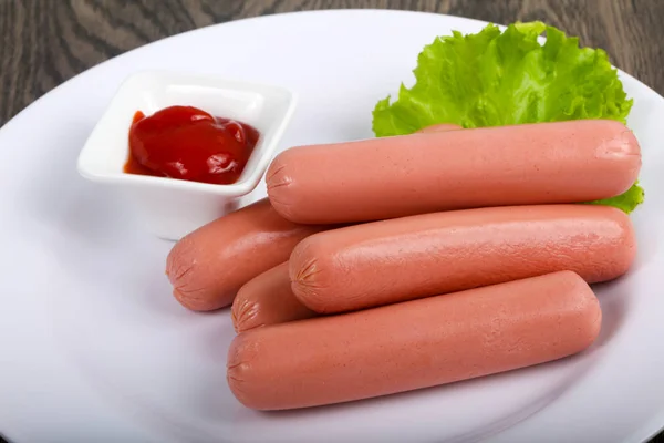 Boiled sausages with salad and ketchup — Stock Photo, Image