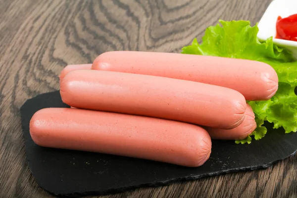 Boiled sausages with salad and ketchup — Stock Photo, Image