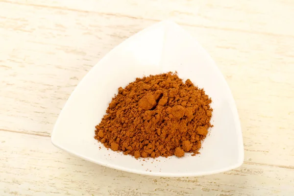 Cocoa powder in white bowl — Stock Photo, Image