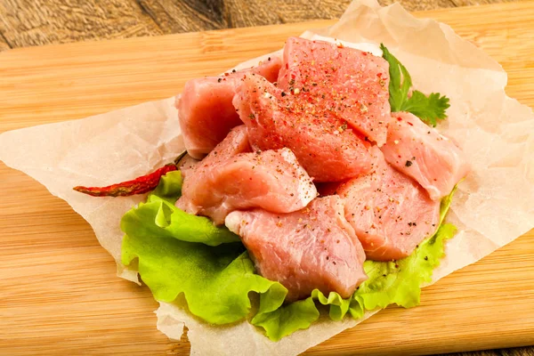 Raw pork pieces on cooking paper — Stock Photo, Image