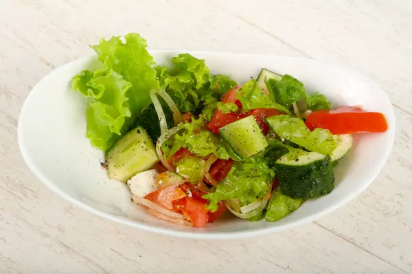 Greek salad in white plate — Stok fotoğraf