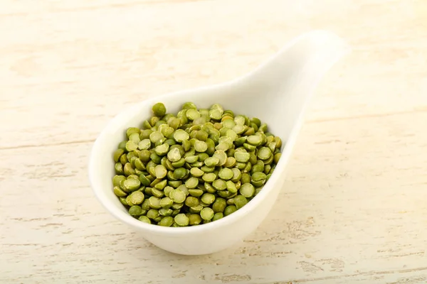 Green peas pile in bowl — Stock Photo, Image