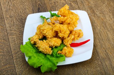 Çıtır tavuk nuggets ahşap arka plan üzerinde baharatlar ile 