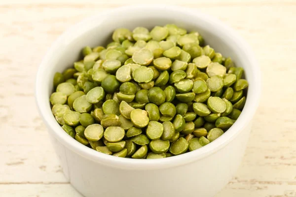 Green peas pile in bowl — Stock Photo, Image