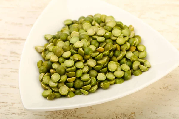 Green peas pile in bowl — Stock Photo, Image