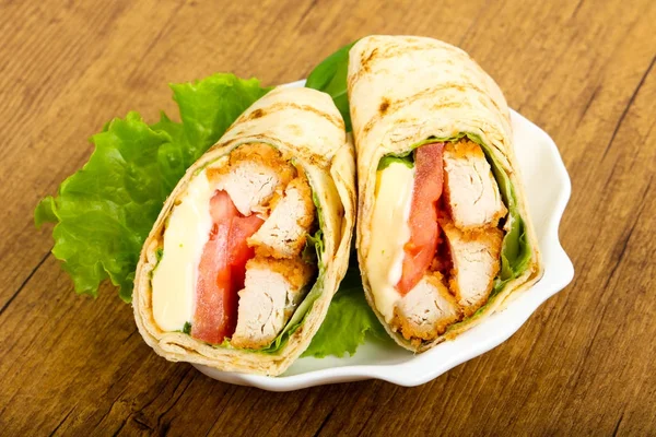 Ahşap arka plan üzerinde tavuk ekmek rulo ile salata yaprakları