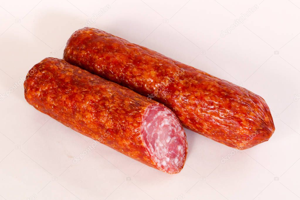 Dry salamy sausage over wooden background