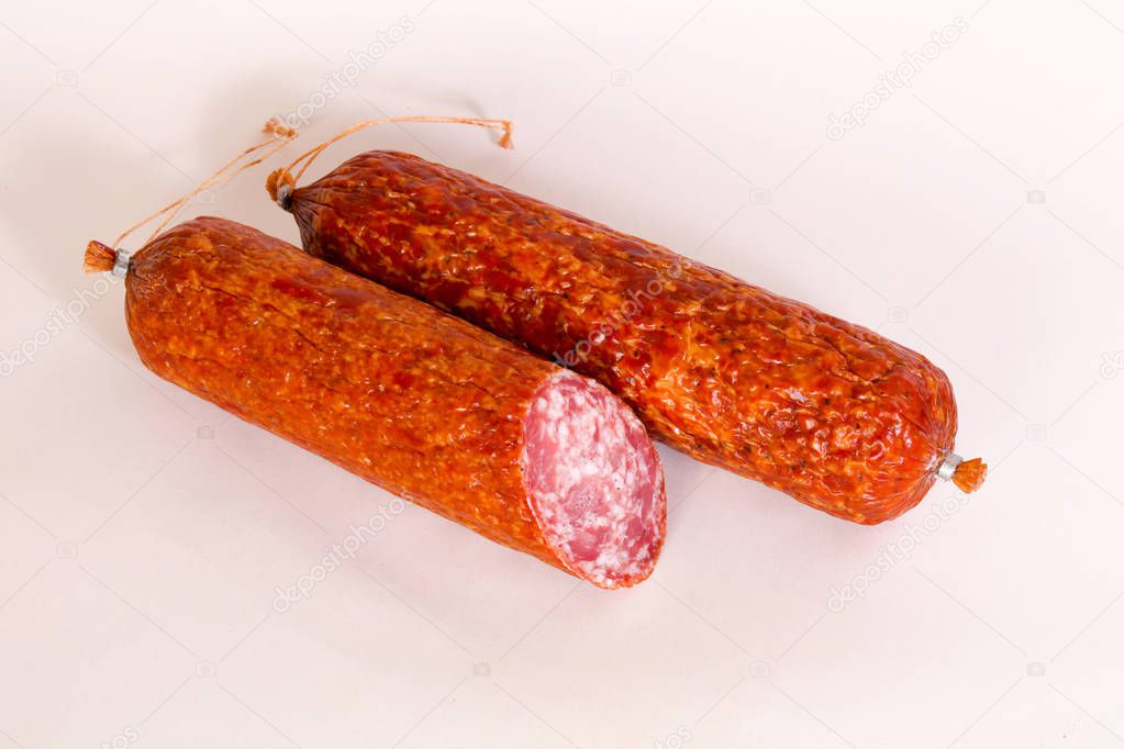 Dry salamy sausage over wooden background