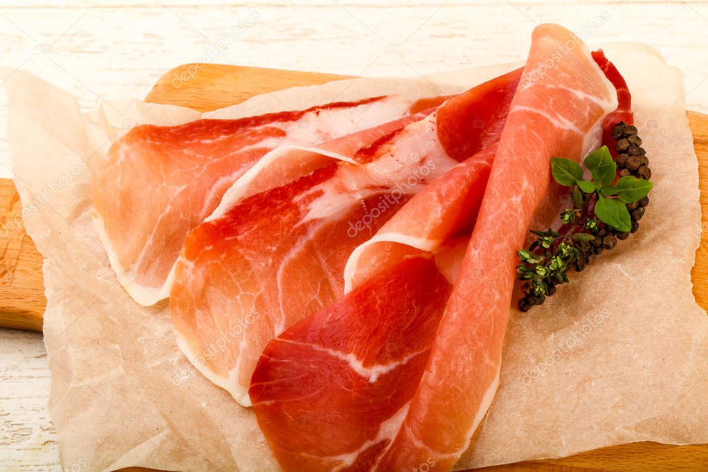 Spanish hamon ready for eat over the wooden background 