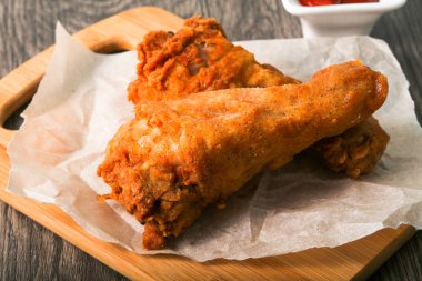 Çıtır tavuk budu ahşap arka plan üzerine ketçap ile