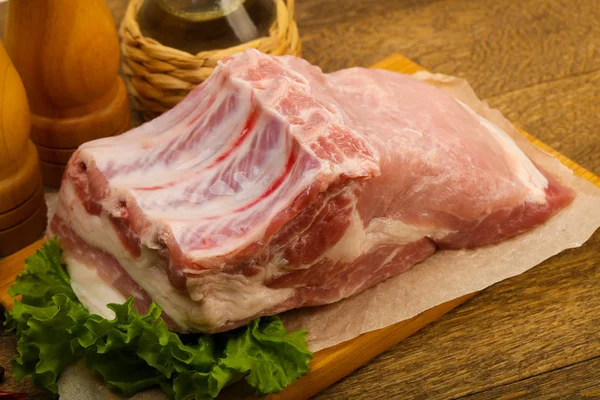 Ahşap arka planda pişirmek için çiğ domuz eti.