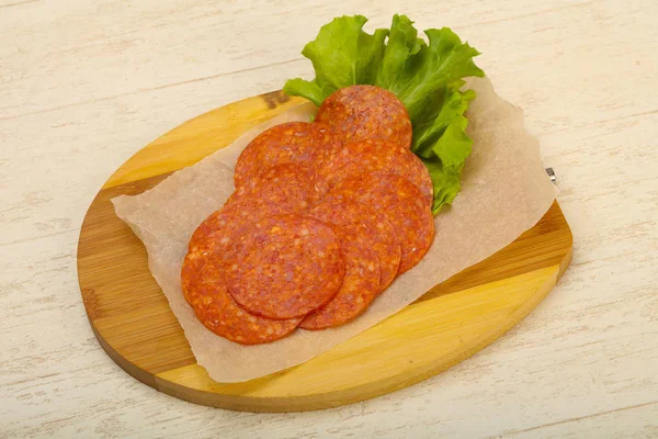 Peperoni Wurst Scheiben Geschnitten Über Hölzernen Hintergrund — Stockfoto