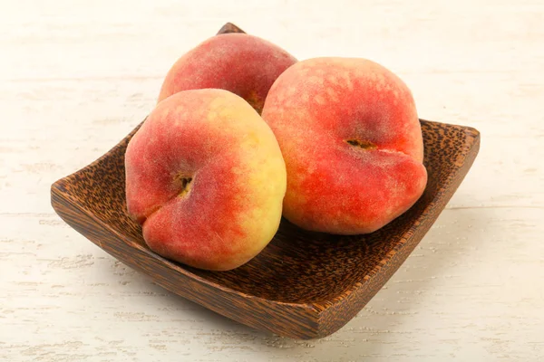 Sweet and juicy peaches over wooden background