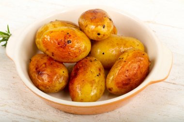 Fırında patates rosemary ile ahşap arka plan üzerinde genç