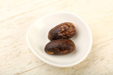 Culinare için iki Nutmegs ahşap arka plan üzerinde kullanın