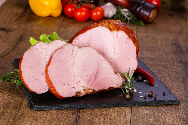 Smoked pork meat over the wooden background