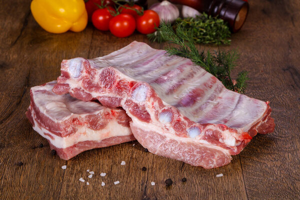Raw pork meat over wooden background