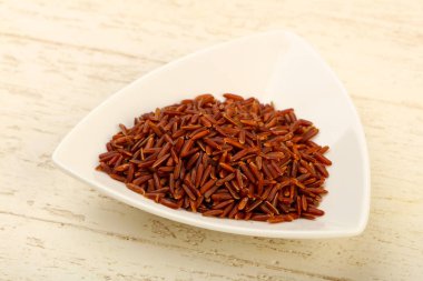 Kase ahşap arka plan üzerinde ham kahverengi pirinç