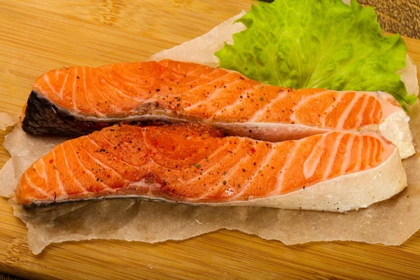 Raw salmon slice ready for baking with spices