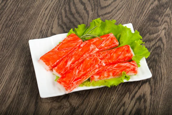 Crab sticks over the wooden background