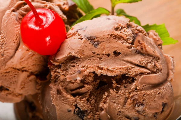 Chocolate ice-cream with mint and cherry