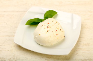 Mozzarella cheese with basil leaves clipart