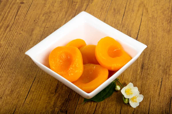 stock image Sweet Canned peaches over wooden background