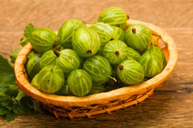 Gooseberries in the bowl with leaf clipart
