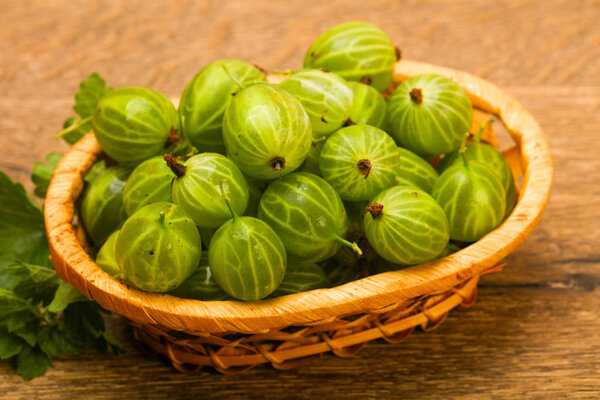 Gooseberries in the bowl with leaf
