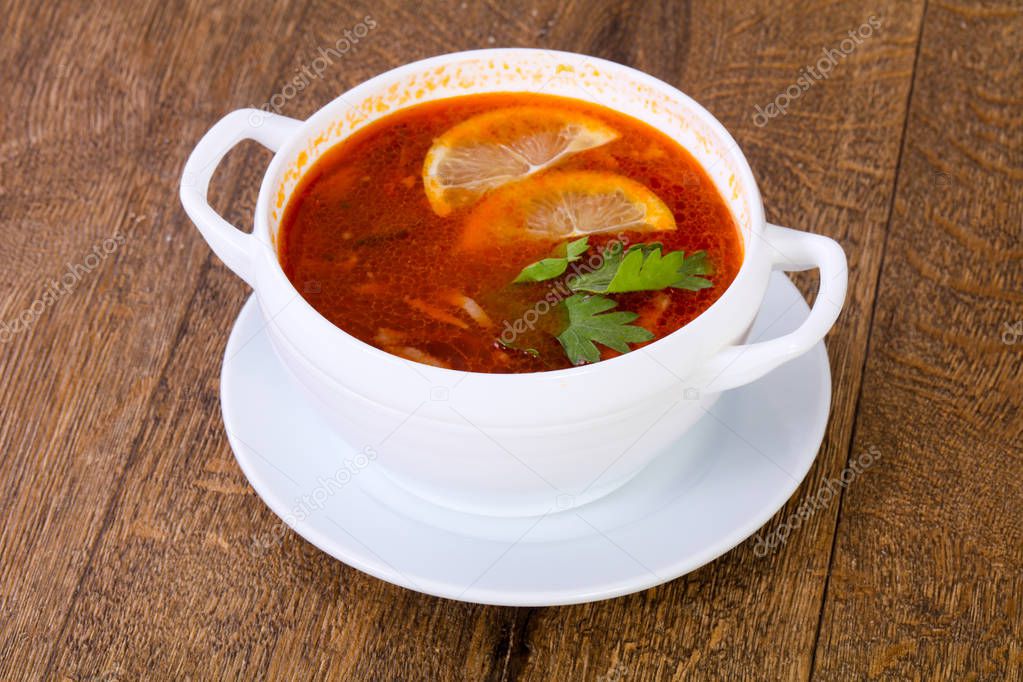 Solyanka soup with lemon serbed parsley