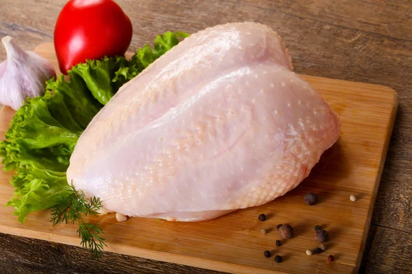 Raw chicken breast with skin