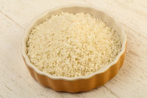 Raw rice heap in the bowl - ready for cooking