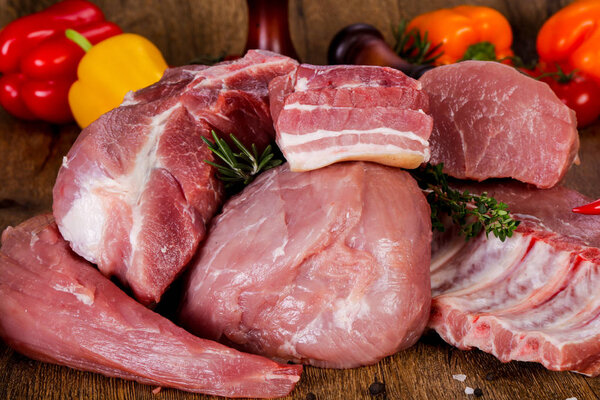 Raw pork meat over wooden background