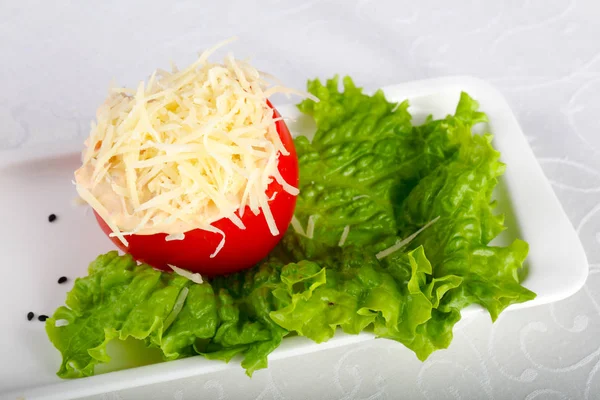 Stuffed tomato with cheese and garlic sauce