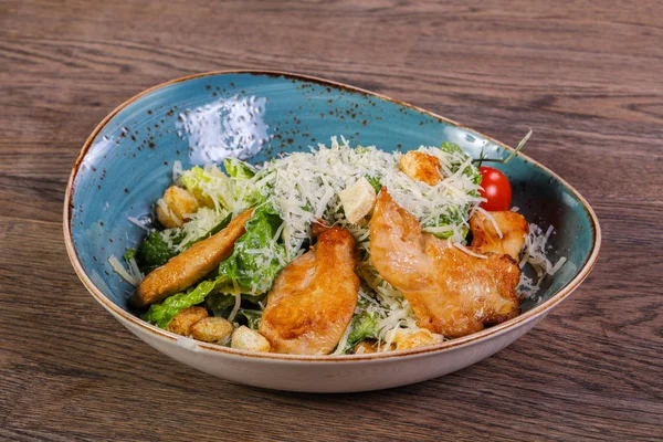 Caesar salad with chicken and parmesan cheese