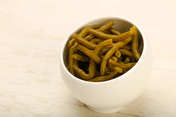 Canned Green beans over wooden background