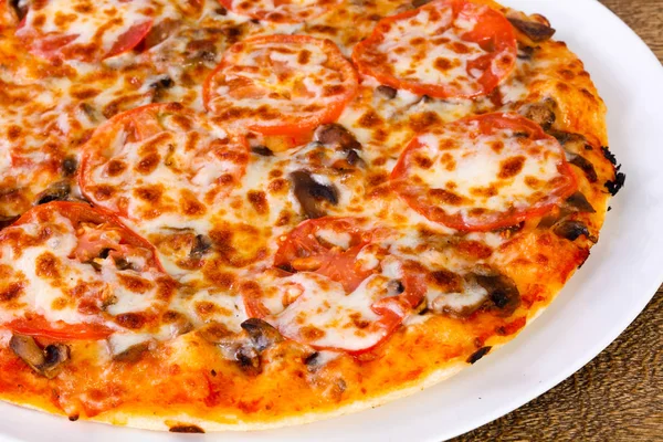 Mushroom pizza with cheese and tomato