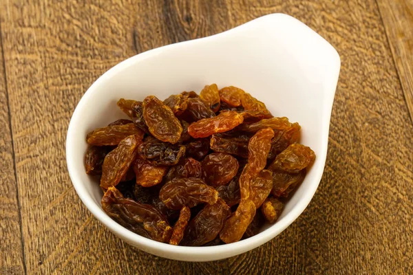 Raisin Secco Nella Ciotola Sullo Sfondo Legno — Foto Stock