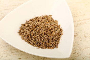 Kimyon tohumları yığın ahşap arka plan üzerinde