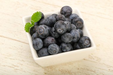 Kase ahşap arka plan üzerinde yabanmersini