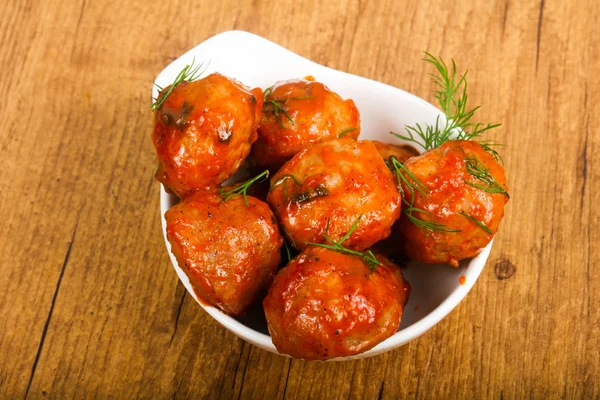 Meat balls in tomato sauce served dill