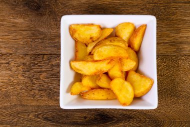 Ahşap arka plan üzerinde rustik lezzetli patates