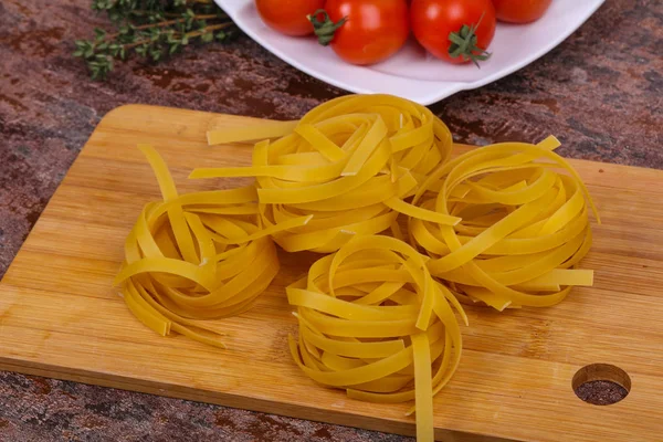 Raw pasta fettuccini — Stock Photo, Image