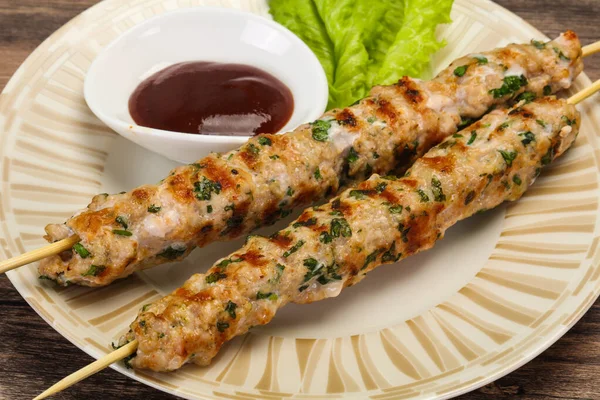 Minced pork skewer kebab with sauce — Stock Photo, Image