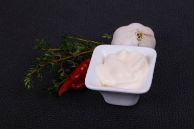 Mayonnaise sauce in the white bowl served thyme and garlic clipart