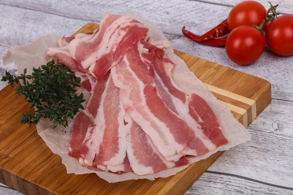 Raw bacon on the board — Stock Photo, Image