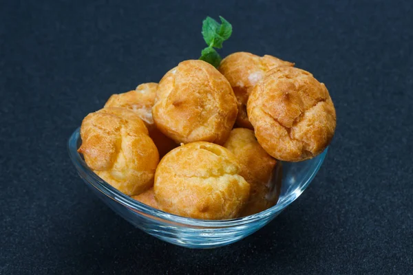 Sweet tasty profiteroles heap in the bowl — Stock Photo, Image