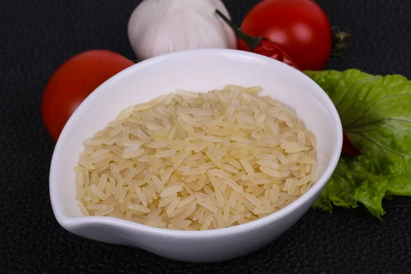 Raw uncooked rice in the bowl — Stock Photo, Image