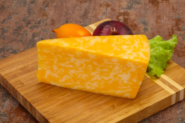 Marble cheese  triangle over wooden background